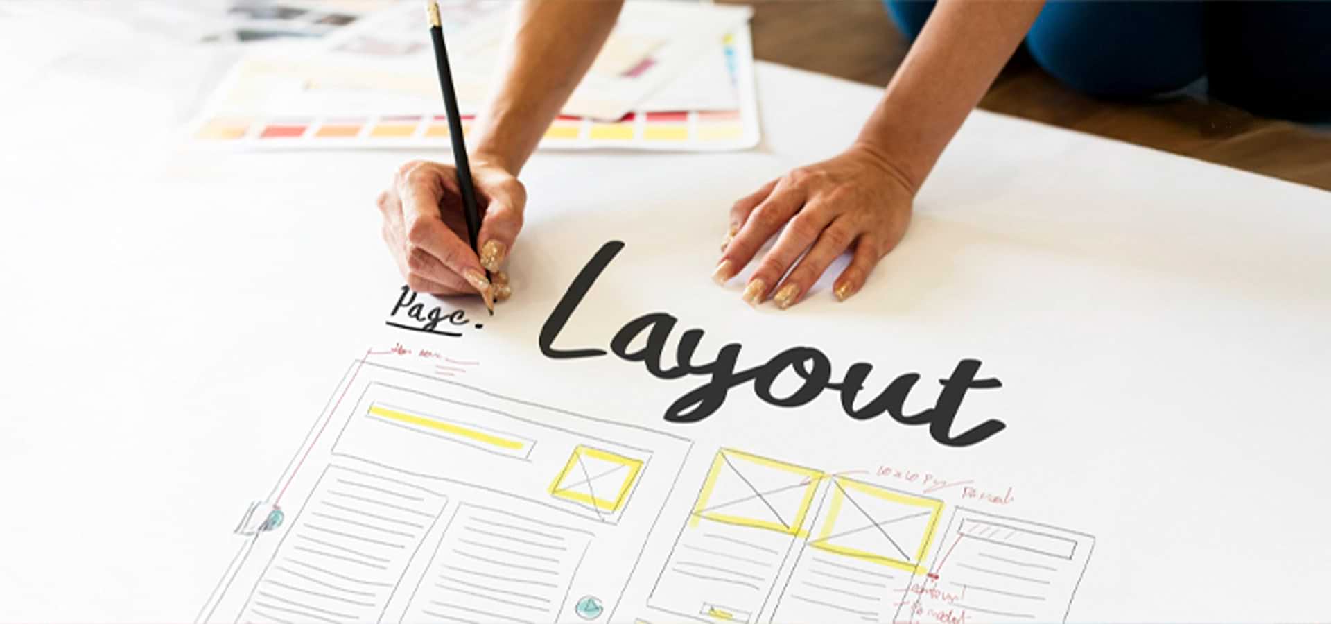 Designer sketching page layout grids for print collateral